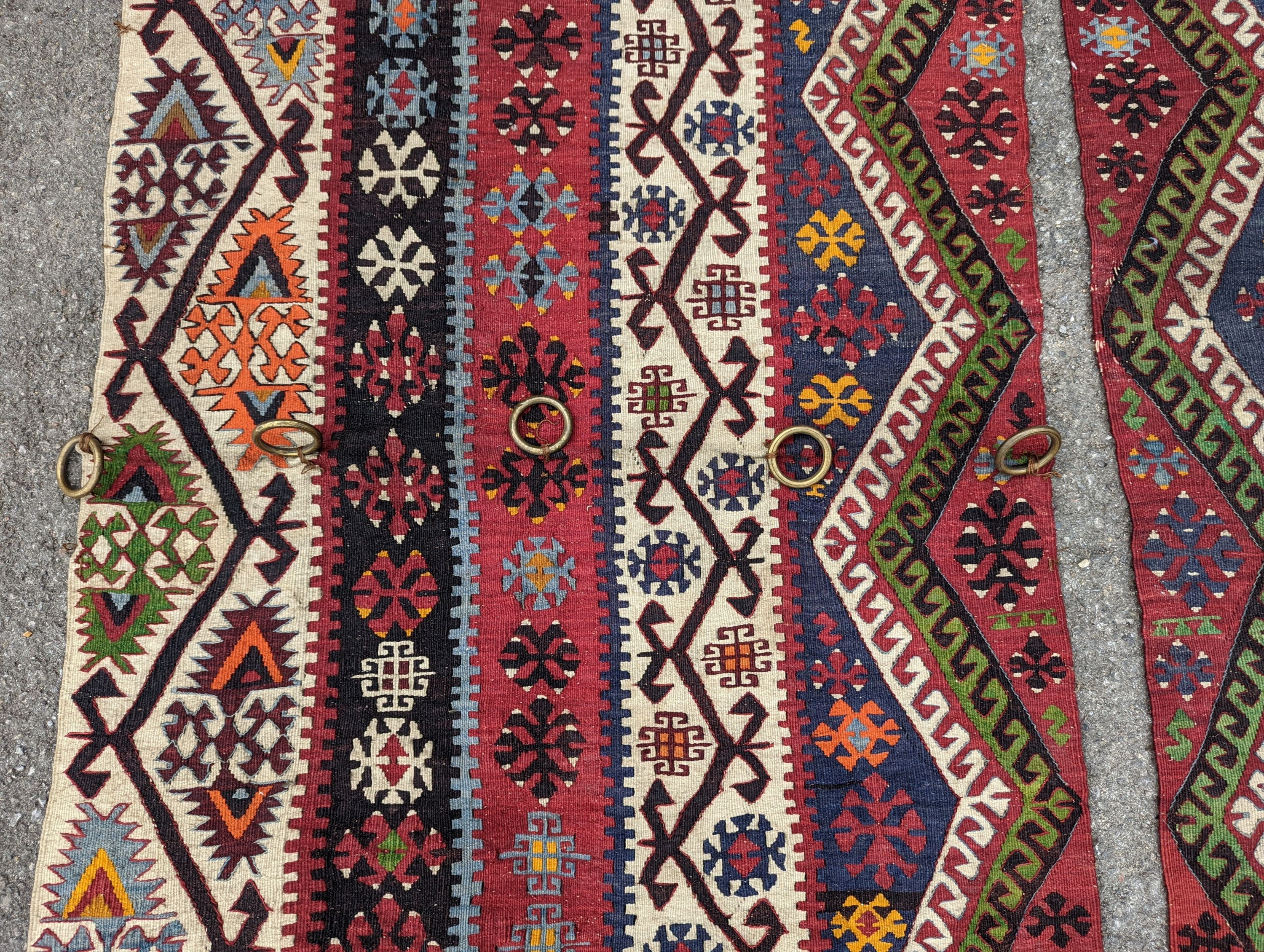 A Kilim polychrome flatweave carpet, cut centrally to create a pair of runners, each 440 x 97cm